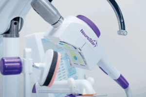 The image showcases a TMS system, a non-invasive brain stimulation therapy that may be utilized to address various neurological or psychiatric disorders.