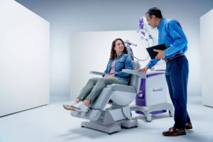 A doctor guides a patient through TMS treatment, addressing concerns like can depression come back after TMS. 