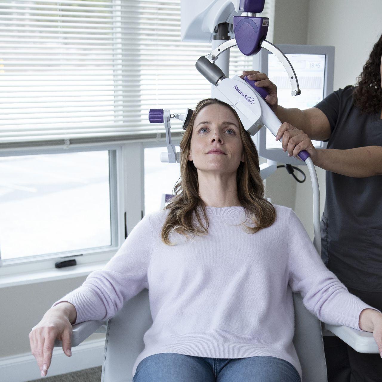 Woman undergoes TMS therapy, an option parents ask about when researching what is the safest antidepressant for teens.