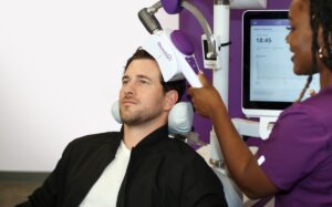 Clinician placing the coil for a theta burst stimulation session targeting treatment resistant depression