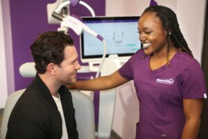 Smiling patient talking with their provider in a clinical office setting after a therapy session.
